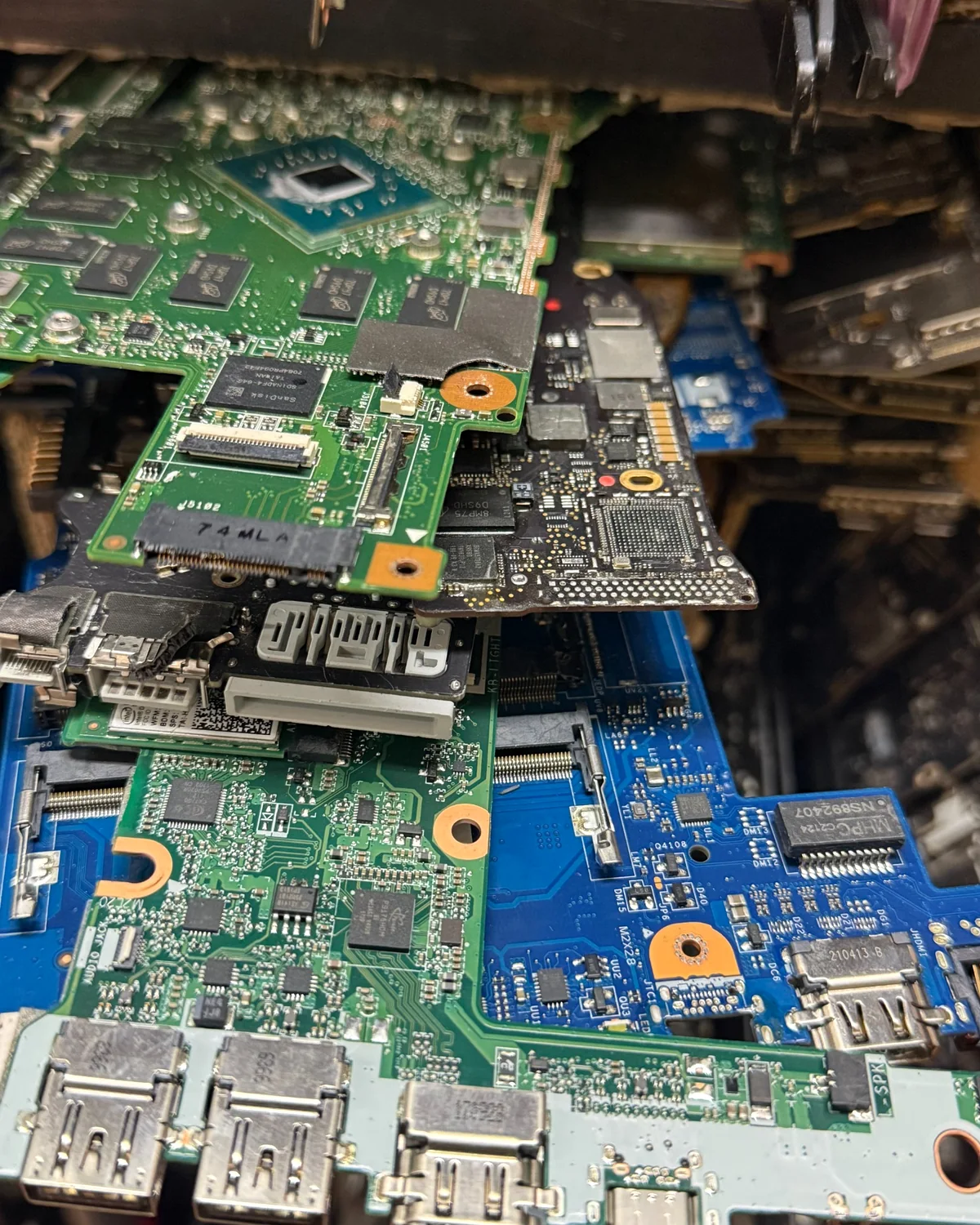 Computer and laptop logic boards at the My Emergency Guy repair bench